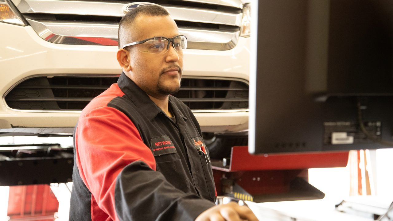 Mechanic using diagnostic computer near vehicle at Network Automotive