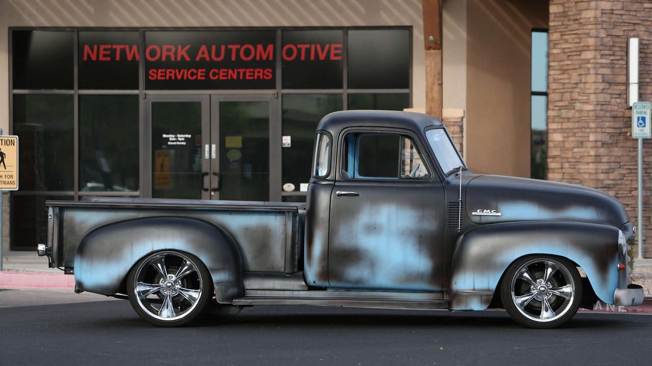Vintage custom pickup truck outside service center at Network Automotive