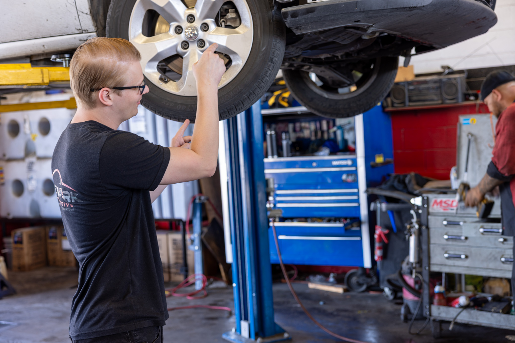ASE certified technician performing brake service
